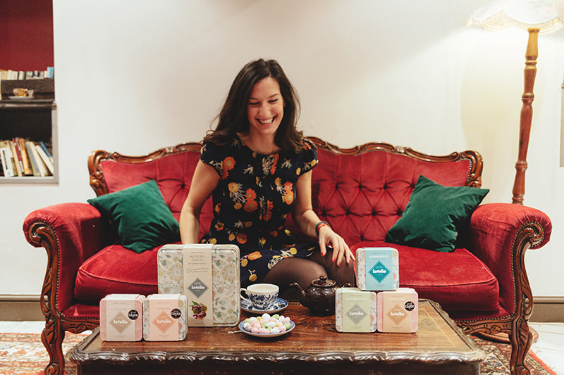 Lavolio - Lavinia Davolio entrepreneur confectionery Profile picture_ red sofa_ Luxury italian confectionery london sweet gift artisan foodie present